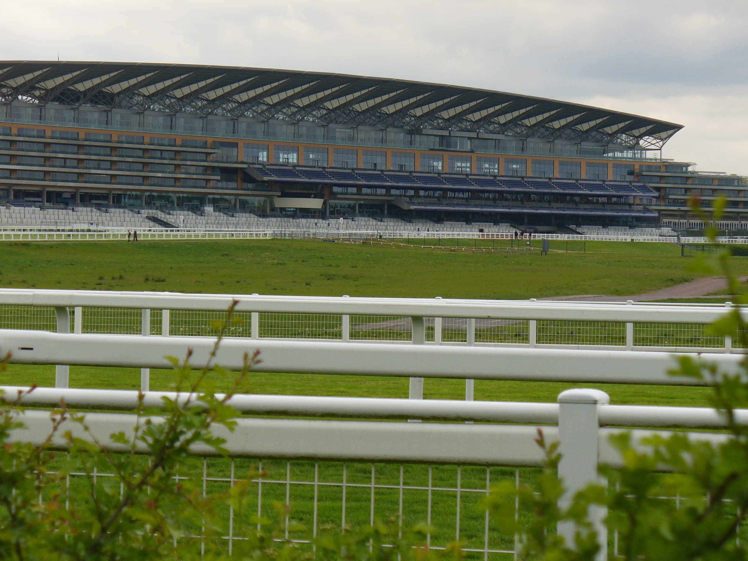 Ascot's grandstand seen across the course from the rails on the far side of the straight.