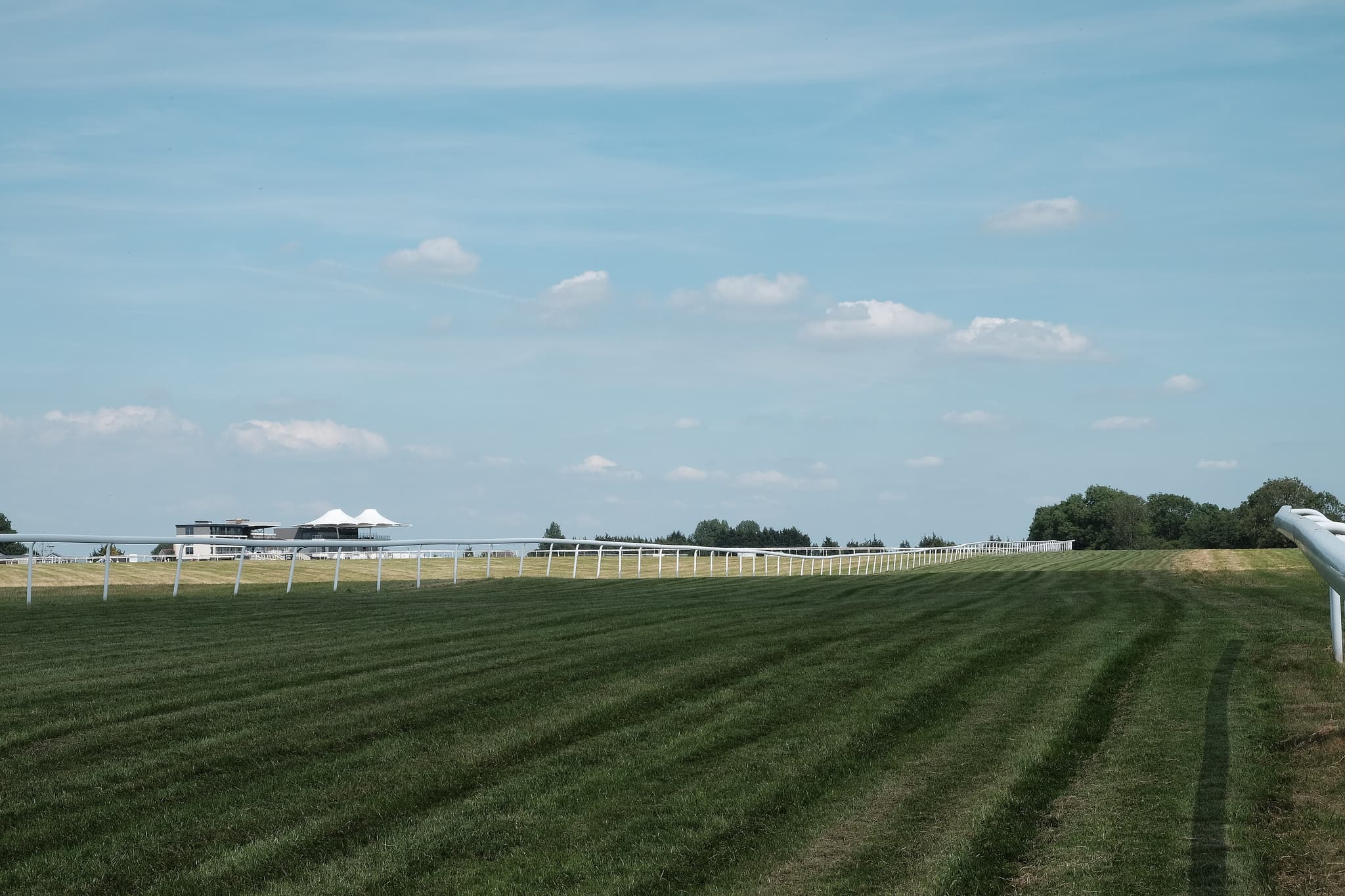 The mown turf of the Bath course running away towards the stands on top of Lansdown Hill.