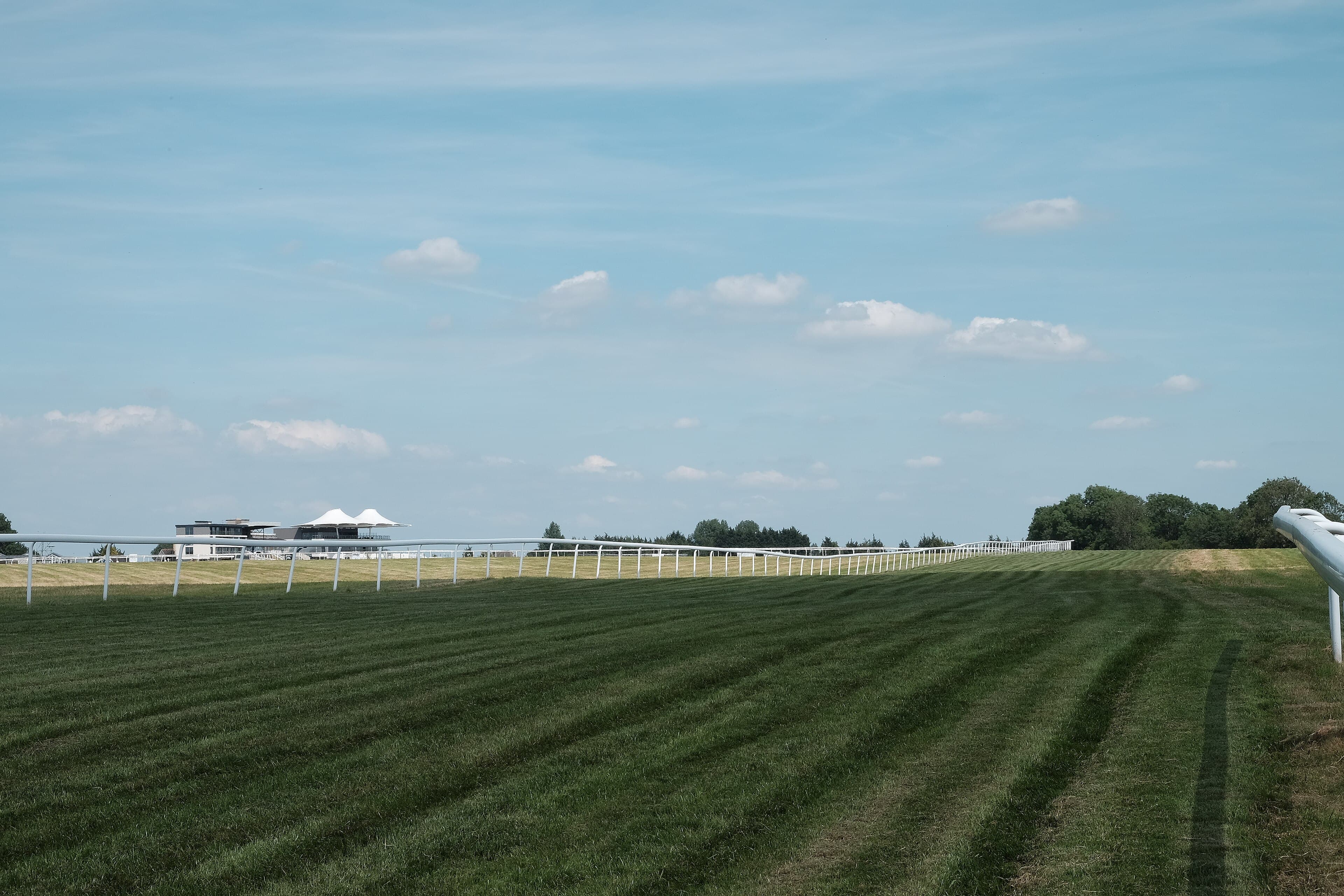 The mown turf of the Bath course running away towards the stands on top of Lansdown Hill.