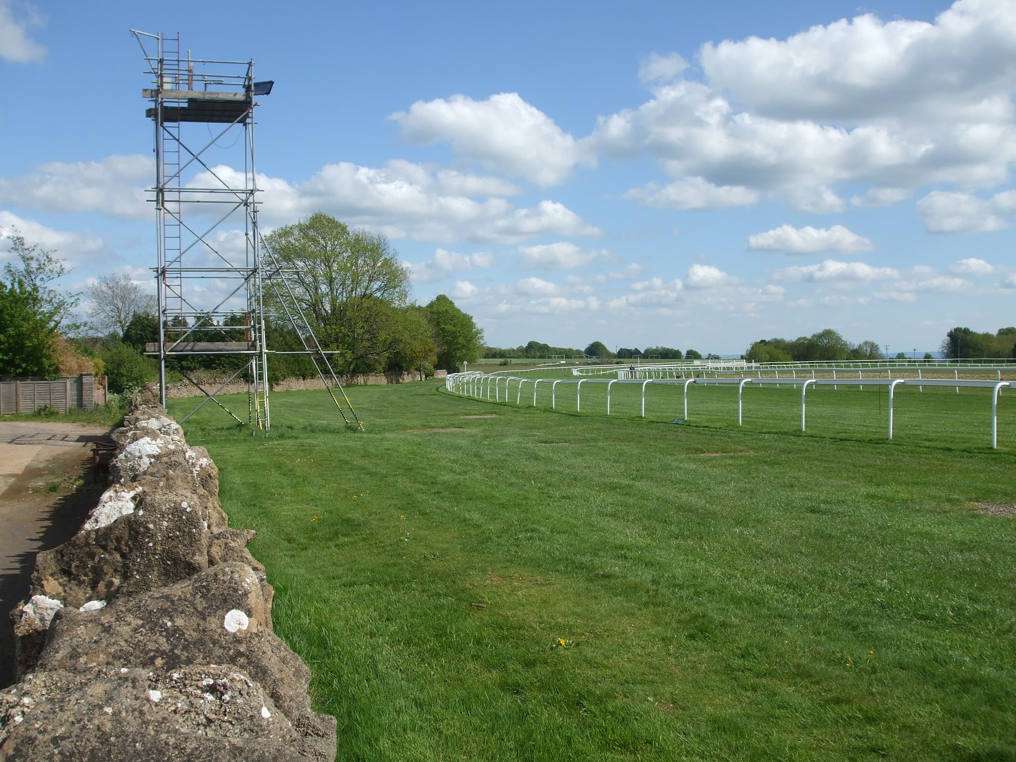 The camera gantry beside the Bath course, the rail running away round the bend in spring sunshine.