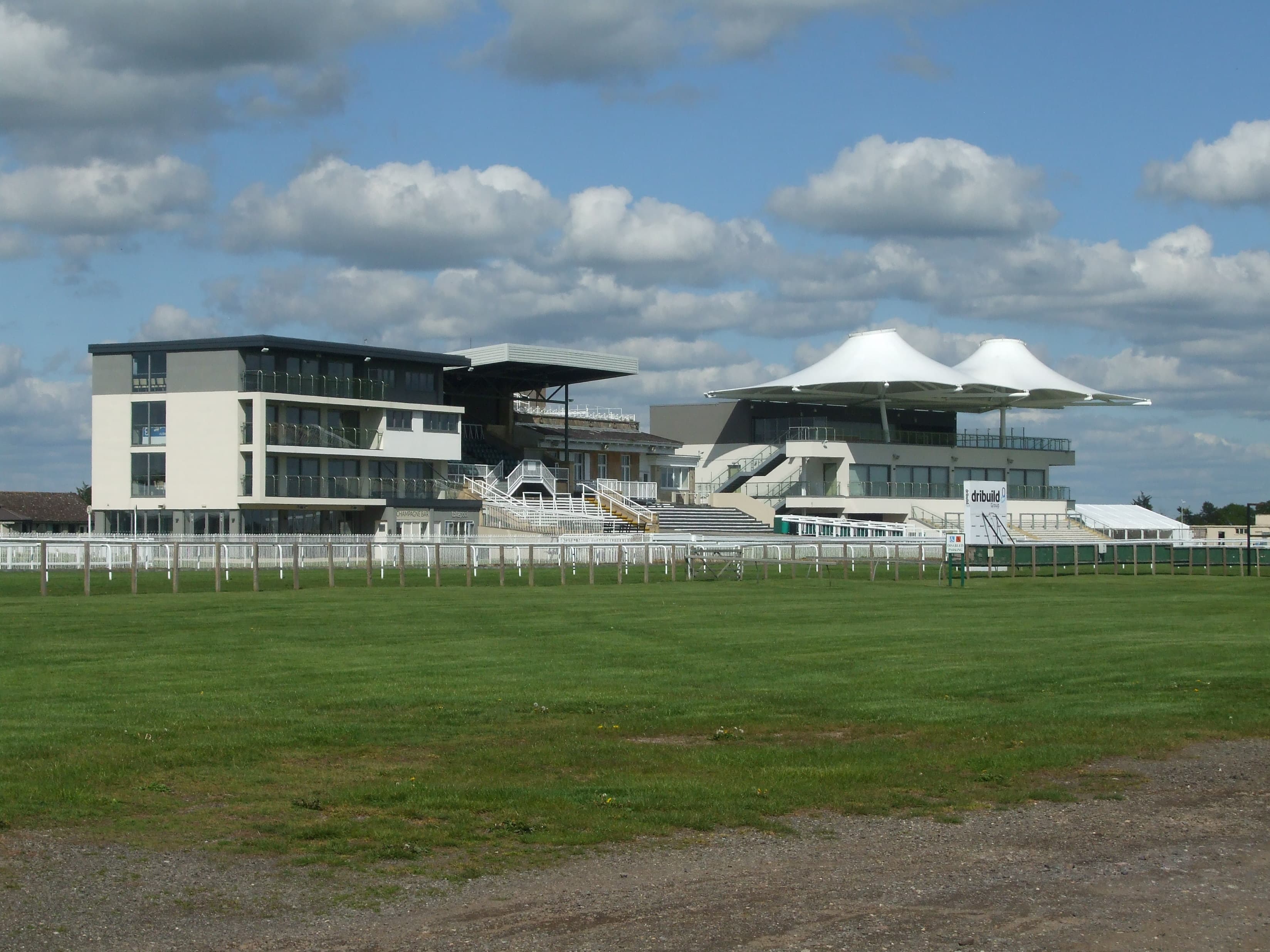 The stands at Bath seen across the course, the tented roof of the newer building to the right.