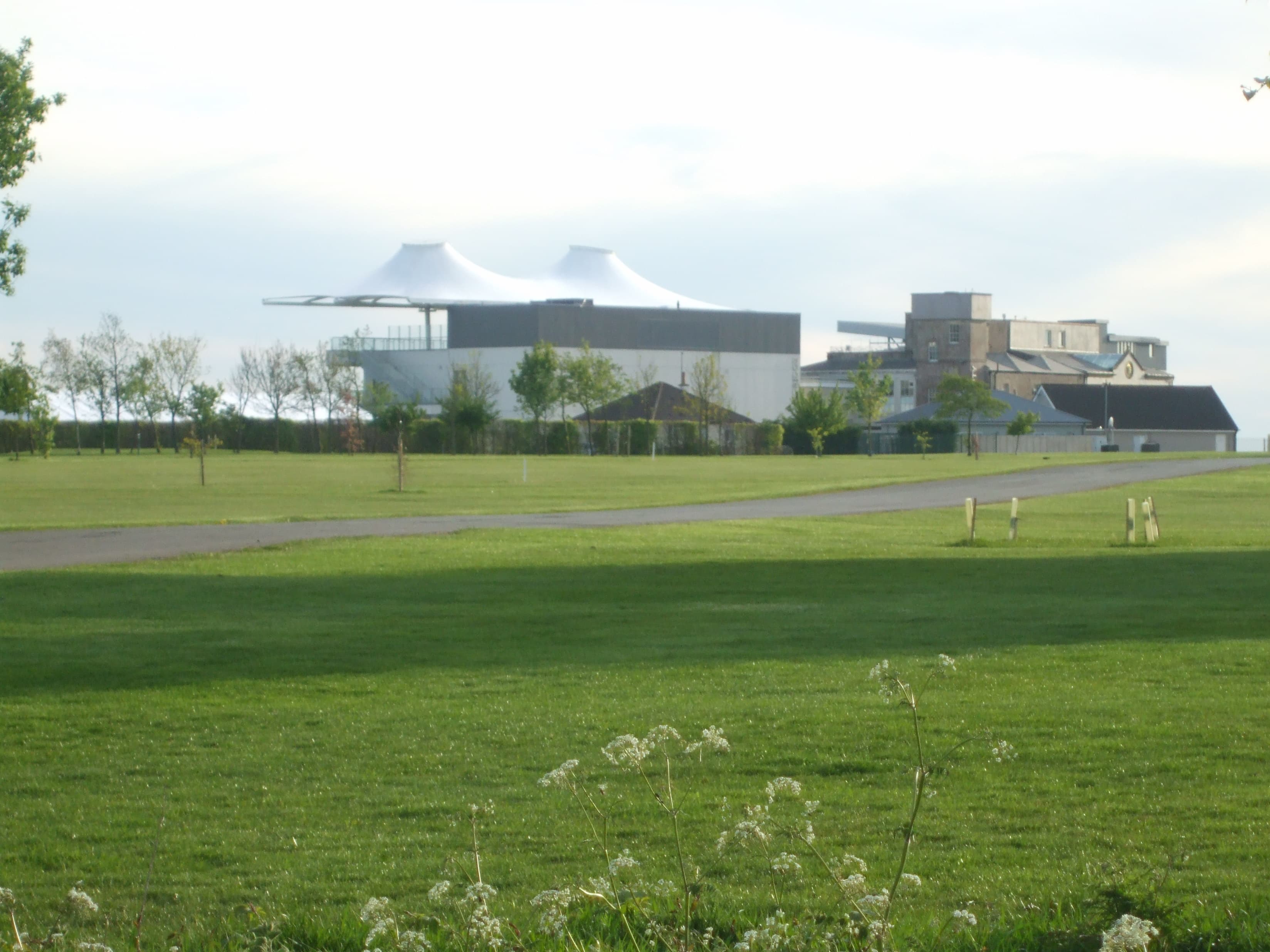 The back of the Bath stands seen across the open ground inside the course.