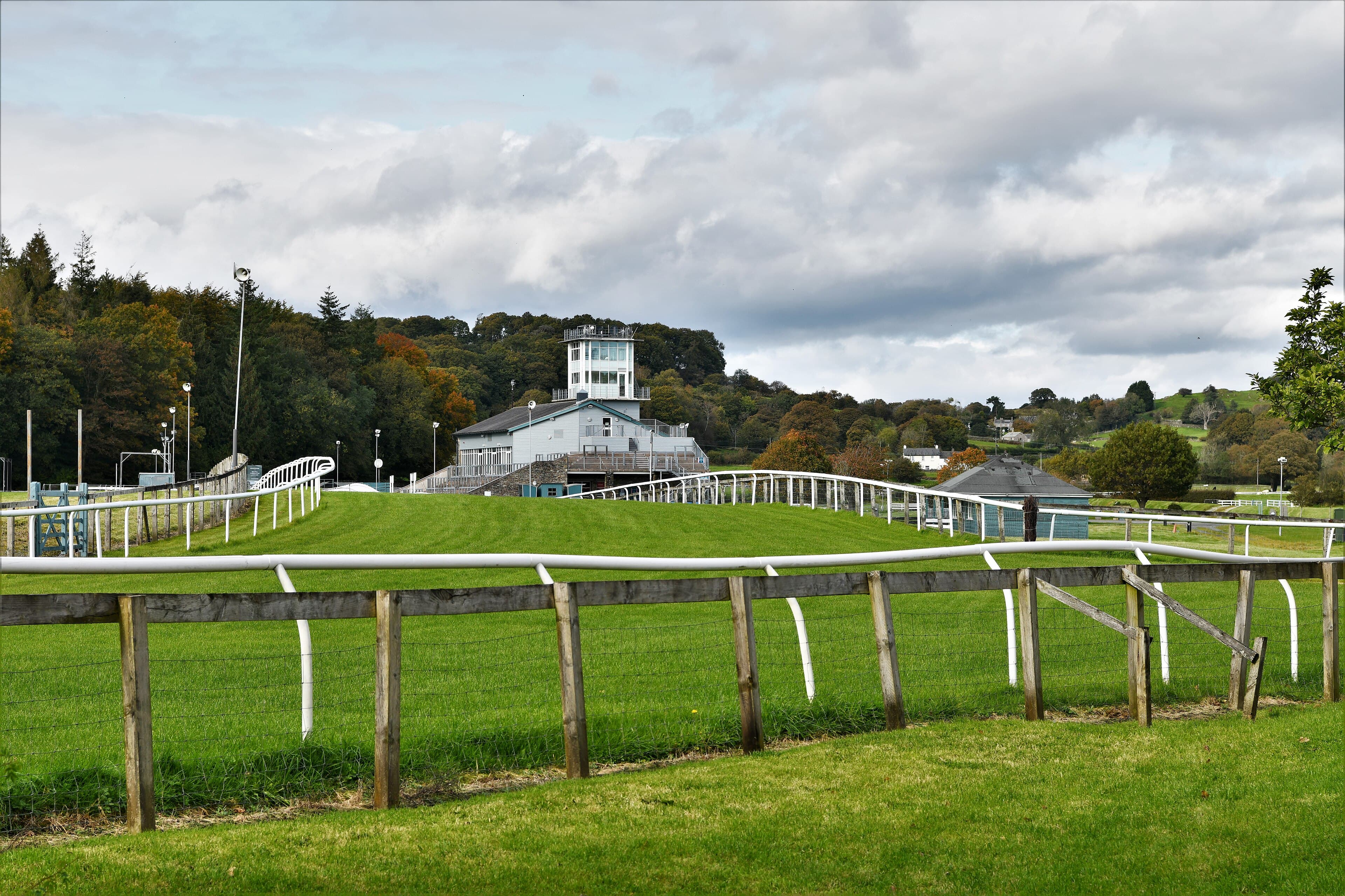 The stand at Cartmel seen over the post and rail fence on an autumn afternoon.