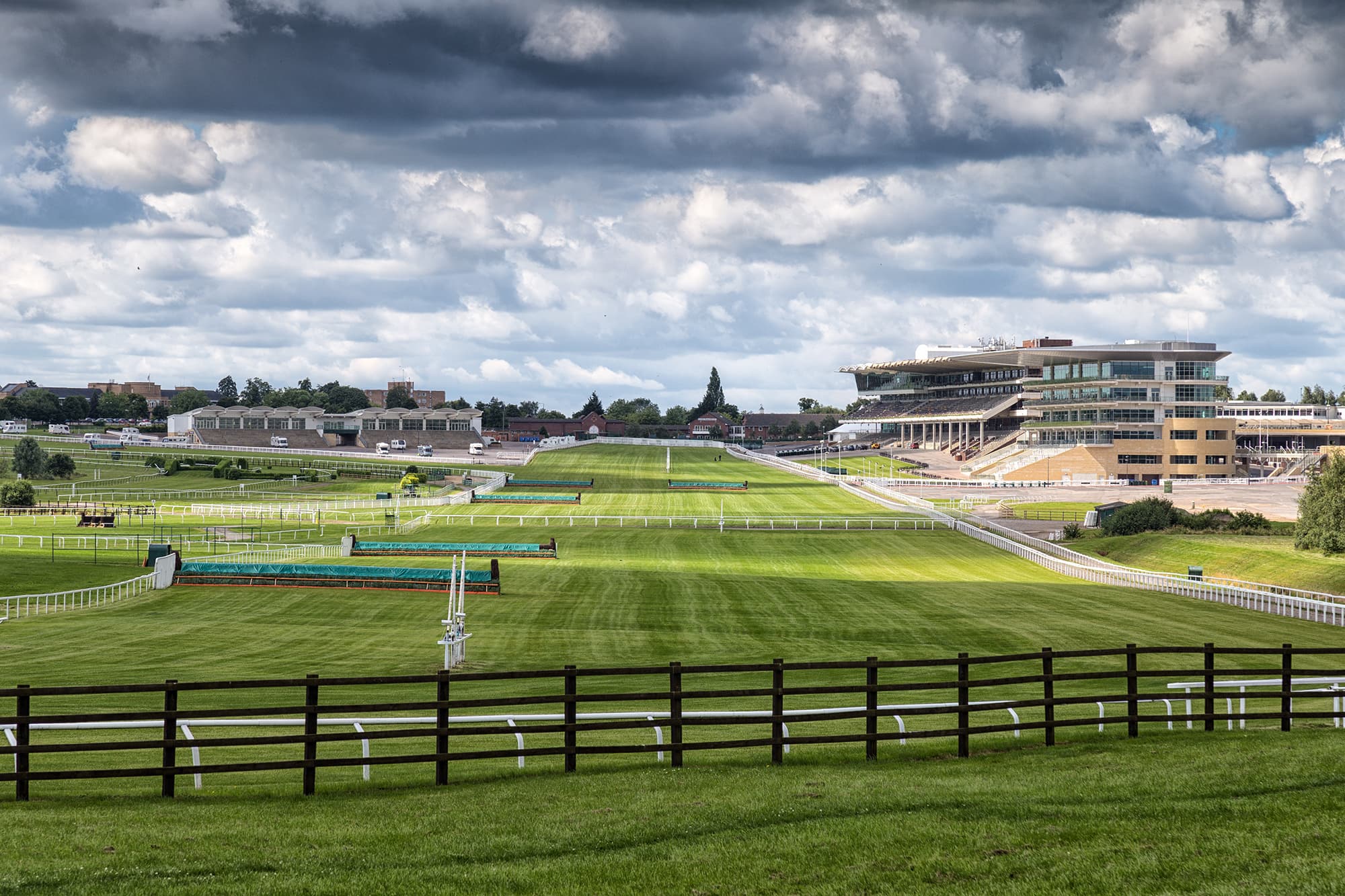 Cheltenham's courses stretching away to the grandstand under a big summer sky.