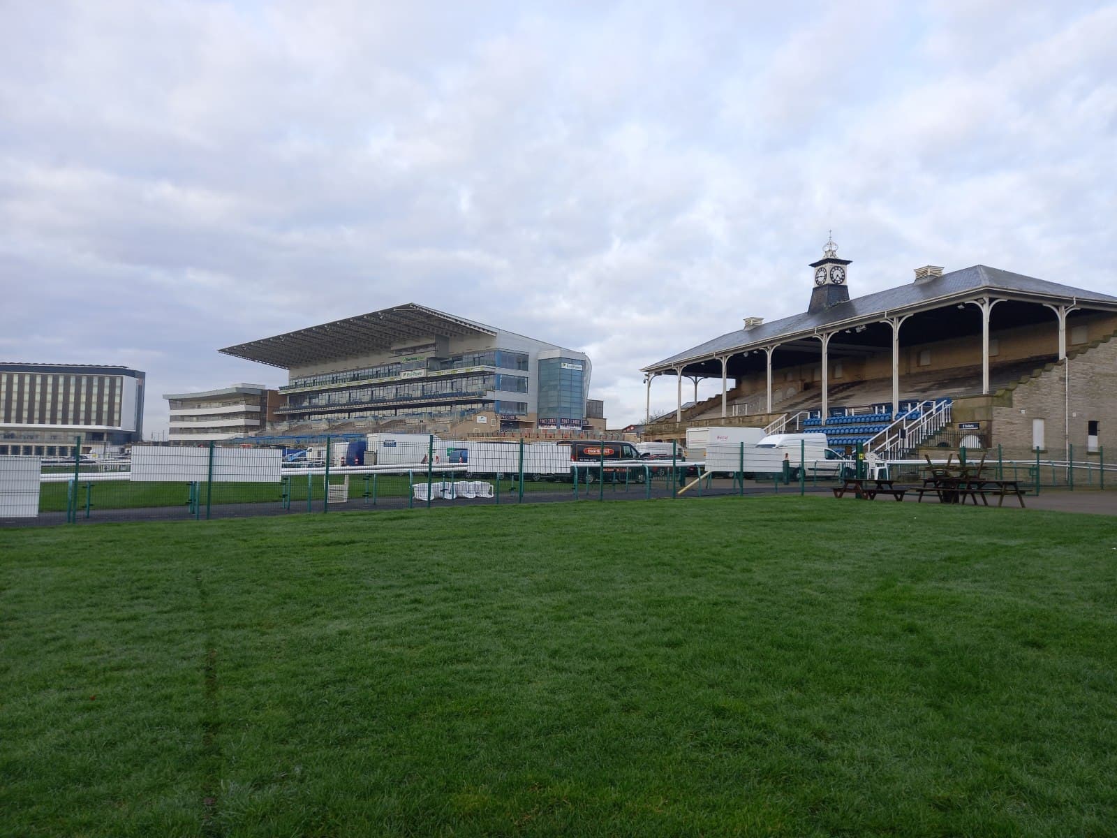 The modern Doncaster grandstand and the Victorian clock tower stand seen across the inside of the course.