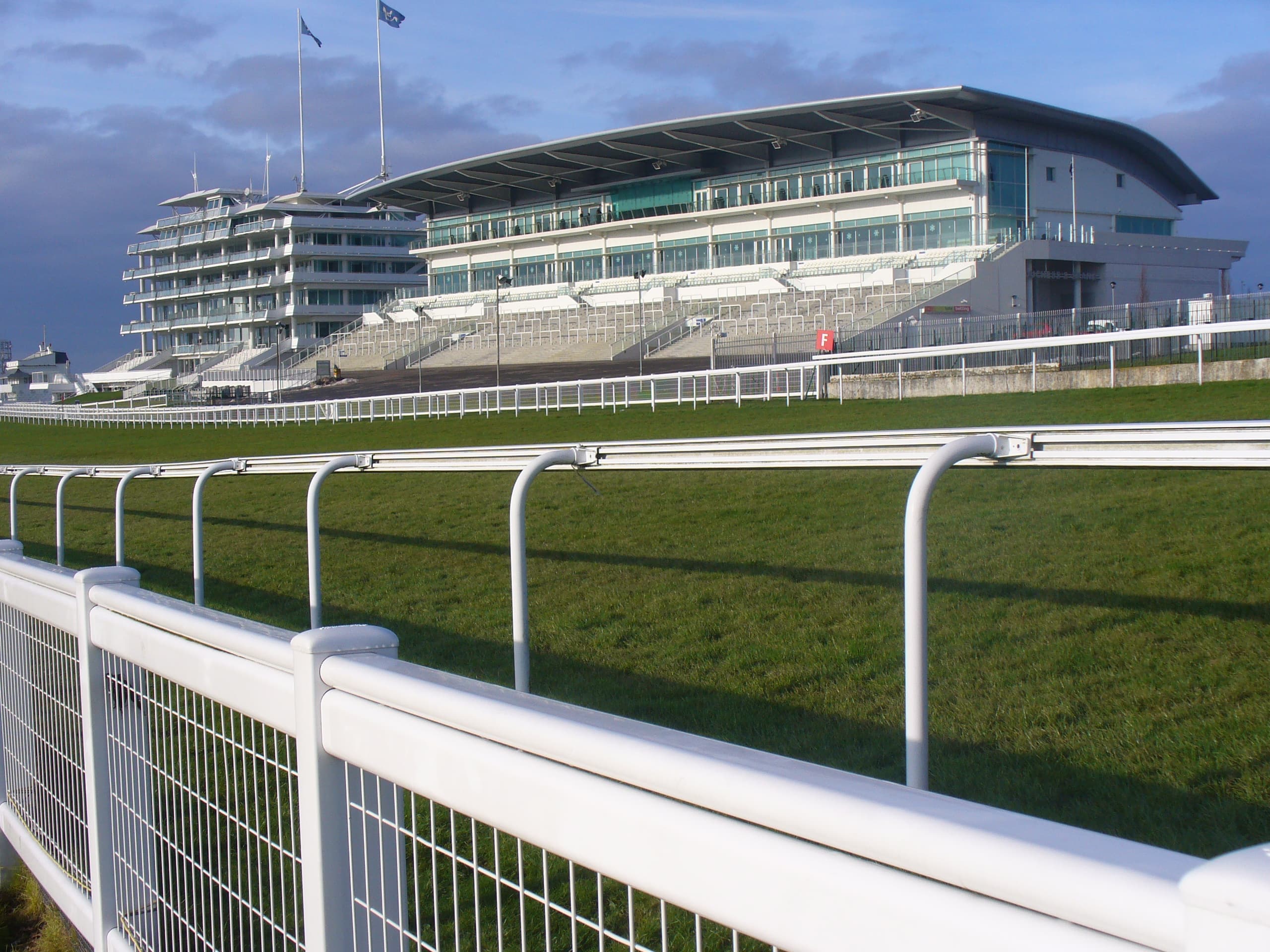 The Queen's Stand and the Duchess's Stand at Epsom seen head on across the running rail.