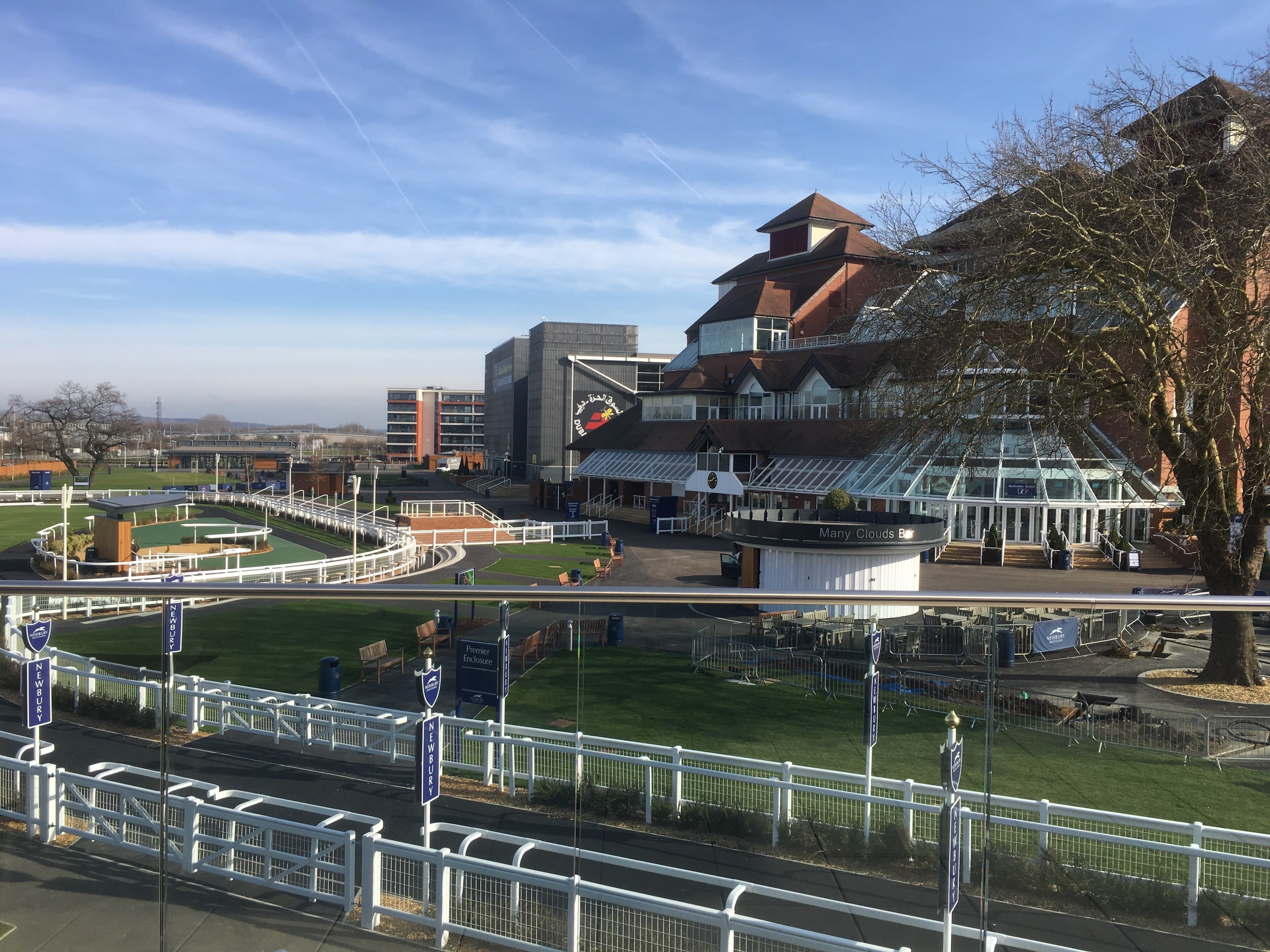 Looking down over the Newbury enclosures from the stand, the Many Clouds Bar and the glasshouse frontage below.