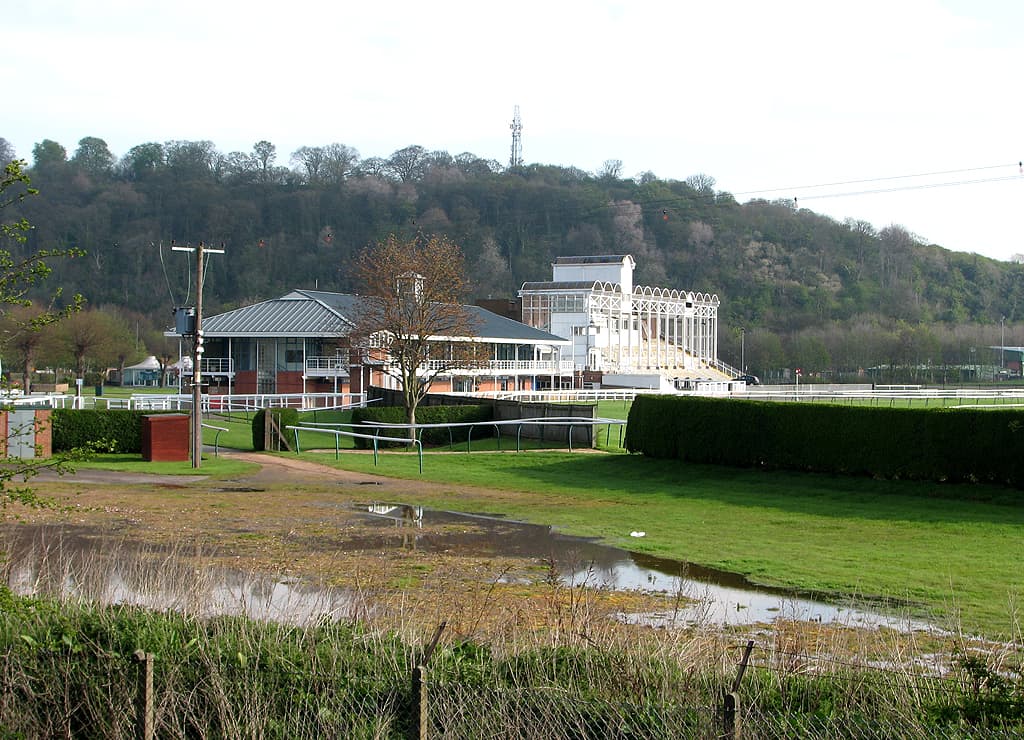 The stands at Nottingham Racecourse seen across a waterlogged corner of the infield in late autumn.
