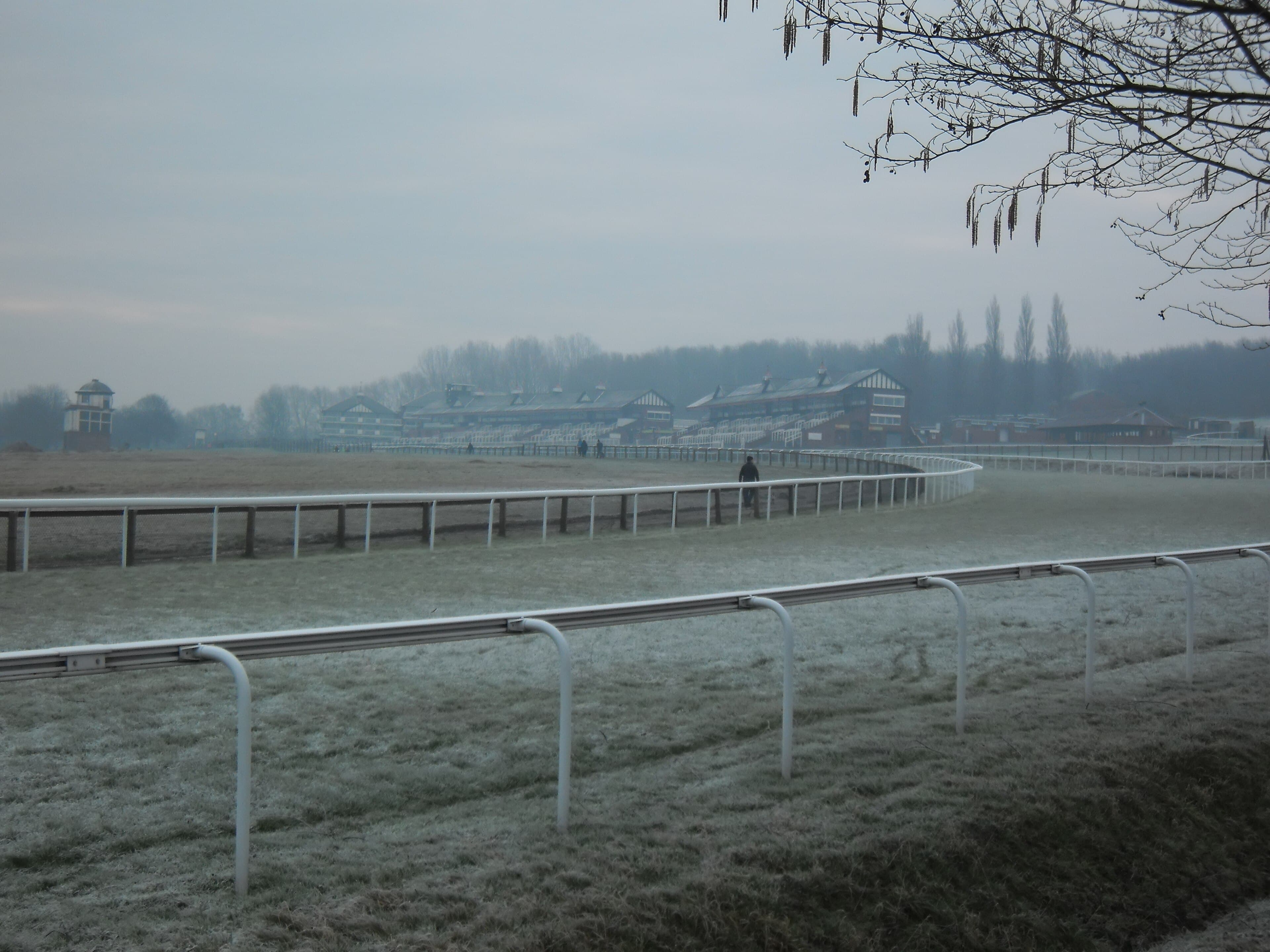 Frost and mist on the bend at Pontefract, the rail curving away towards the stands.