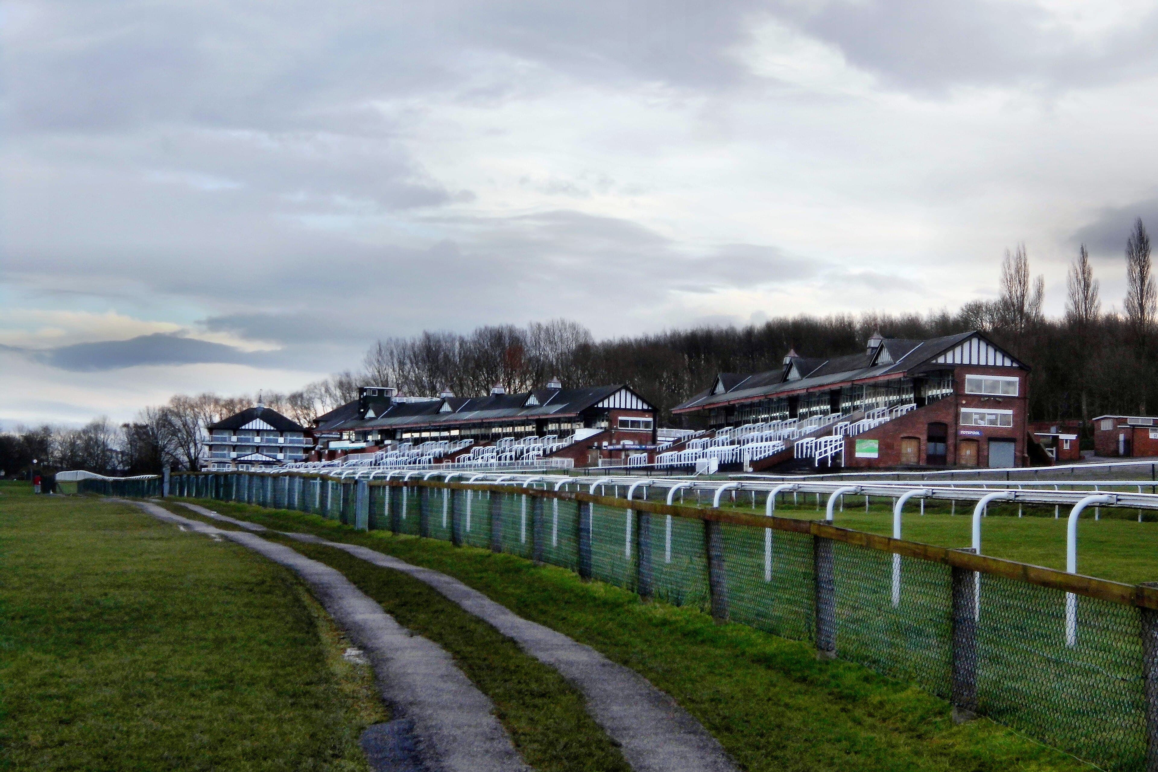 The stands at Pontefract along the home straight, the running rail curving away in front of them.