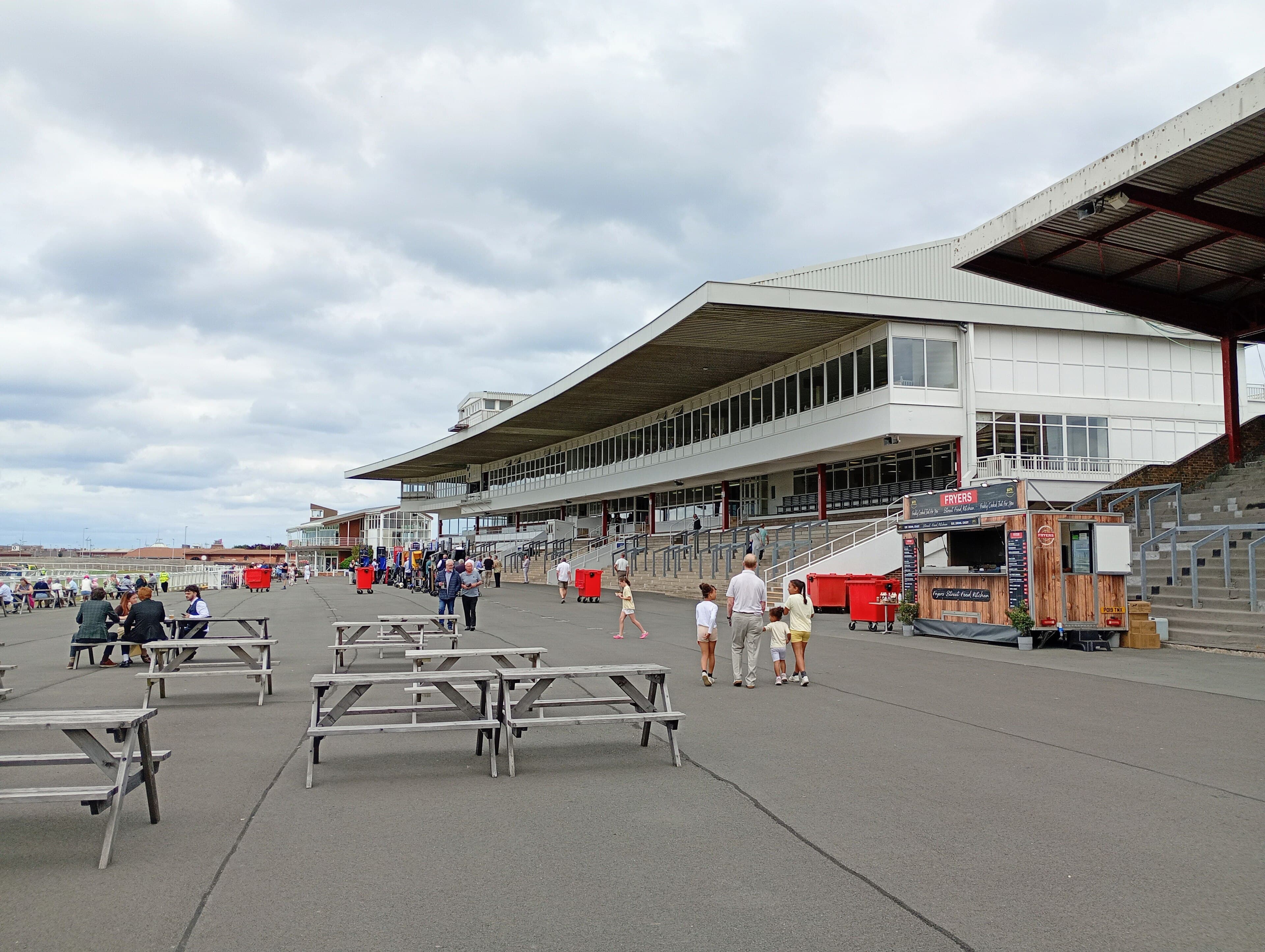 The main stand at Redcar from the southern end of the apron, picnic tables set out in front of it.
