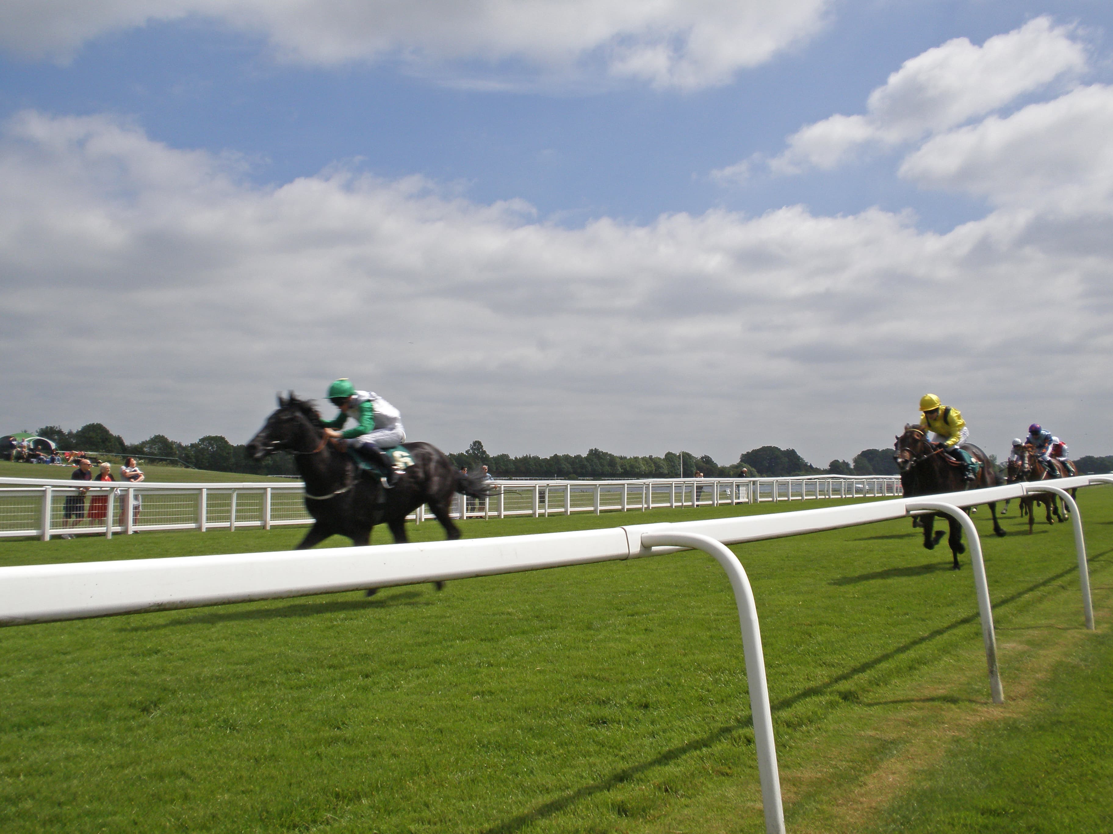 A clear leader racing away down the straight at Ripon on a bright summer day, the rest of the field strung out behind.