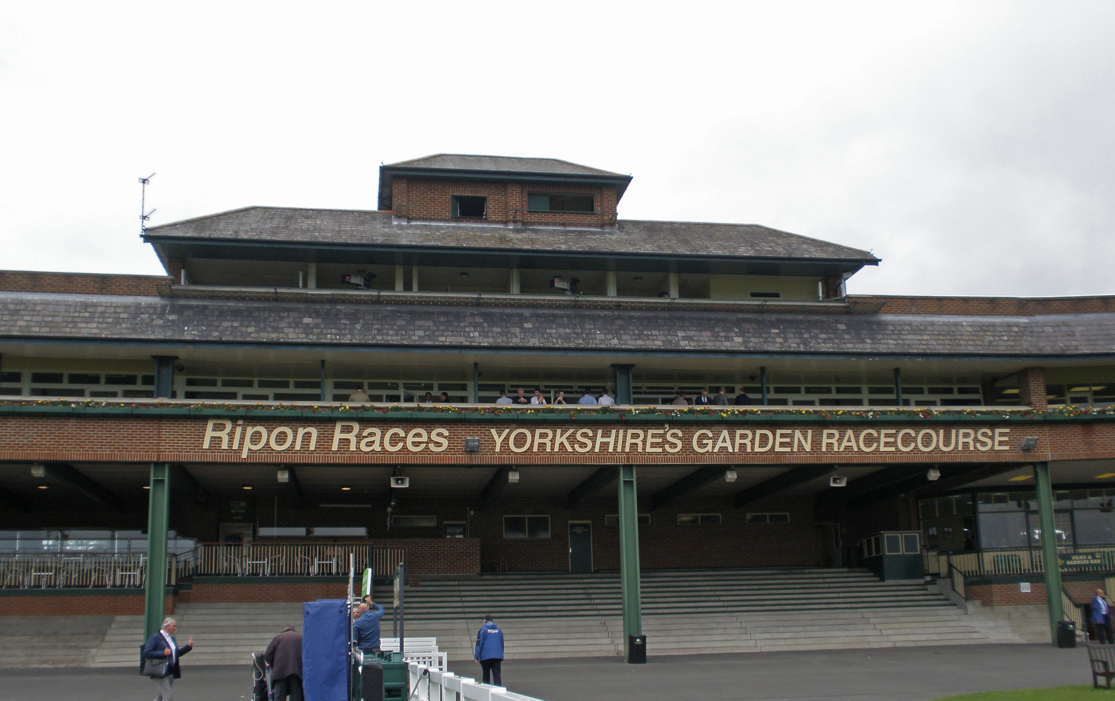 The main stand at Ripon carrying the course name, Yorkshire's Garden Racecourse, above the steps.