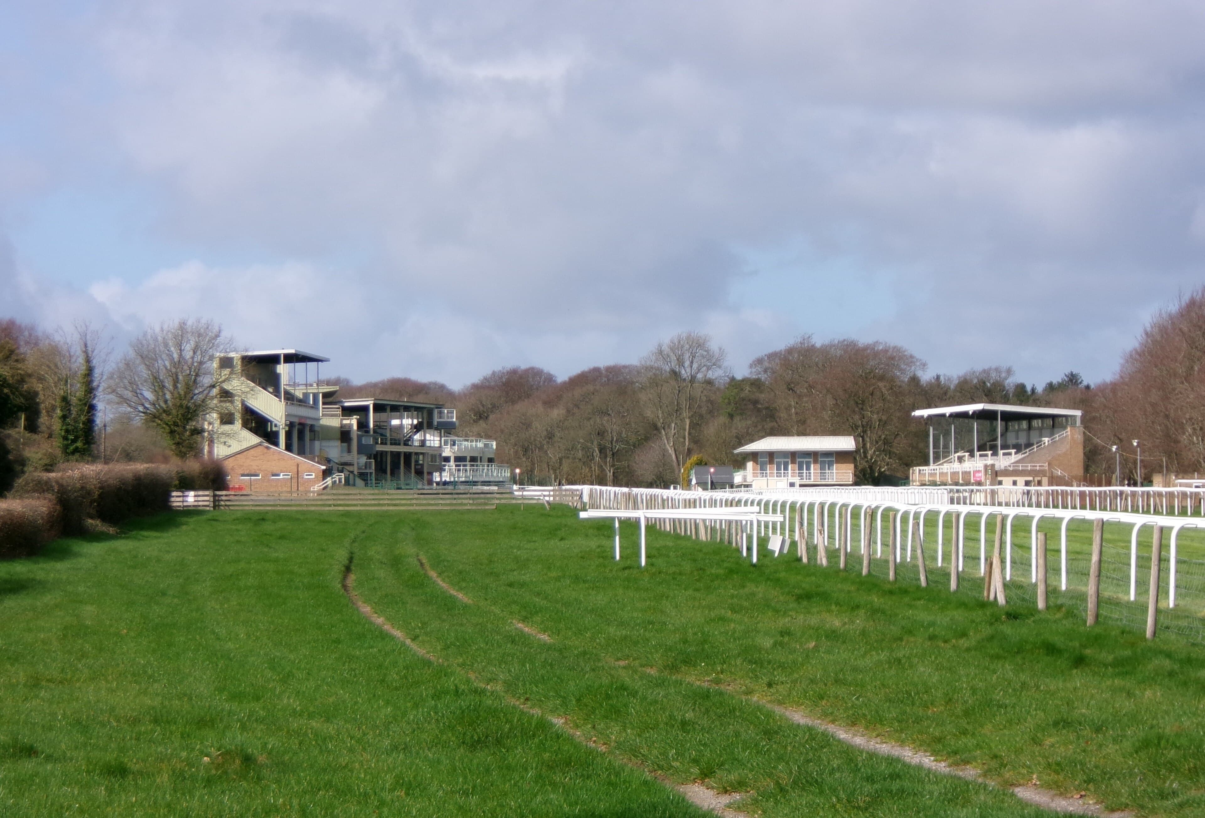 The stands at Salisbury Racecourse seen across the finishing straight on a bright spring day.