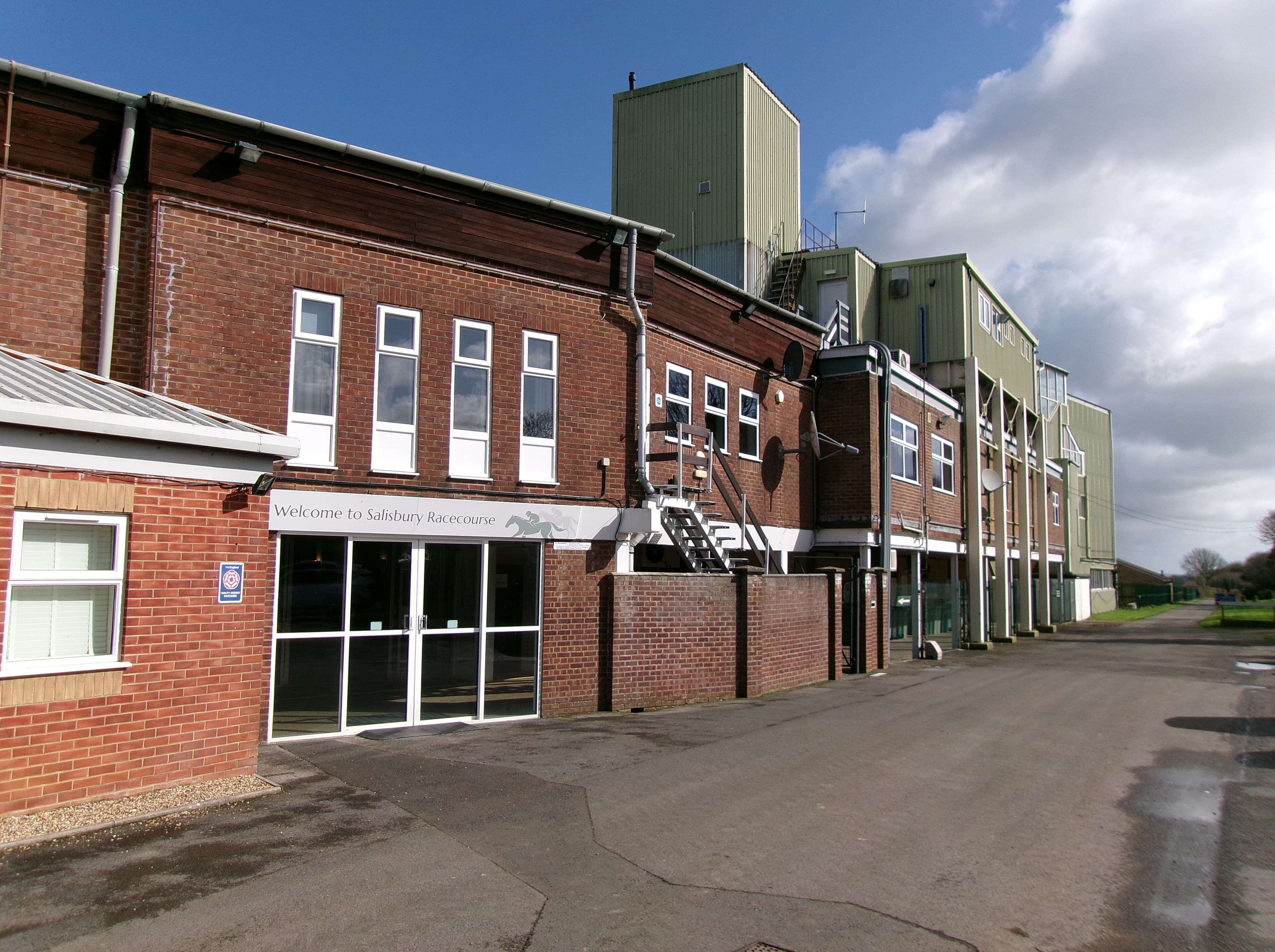 The brick entrance block at Salisbury Racecourse, the welcome sign above its glass doors.