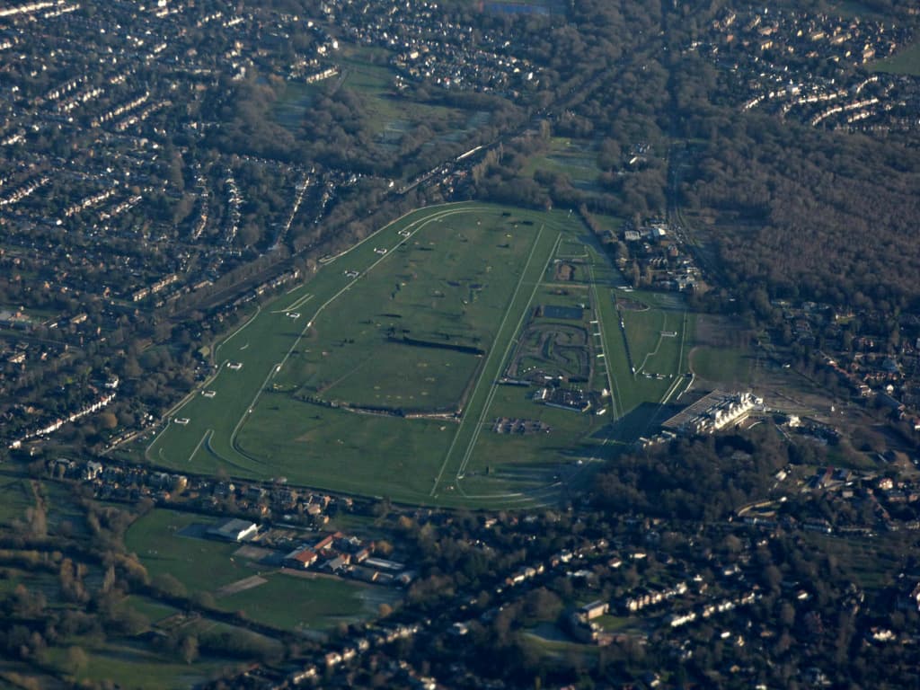 Sandown Park from the air, the whole oval set among the streets and woods of Esher.