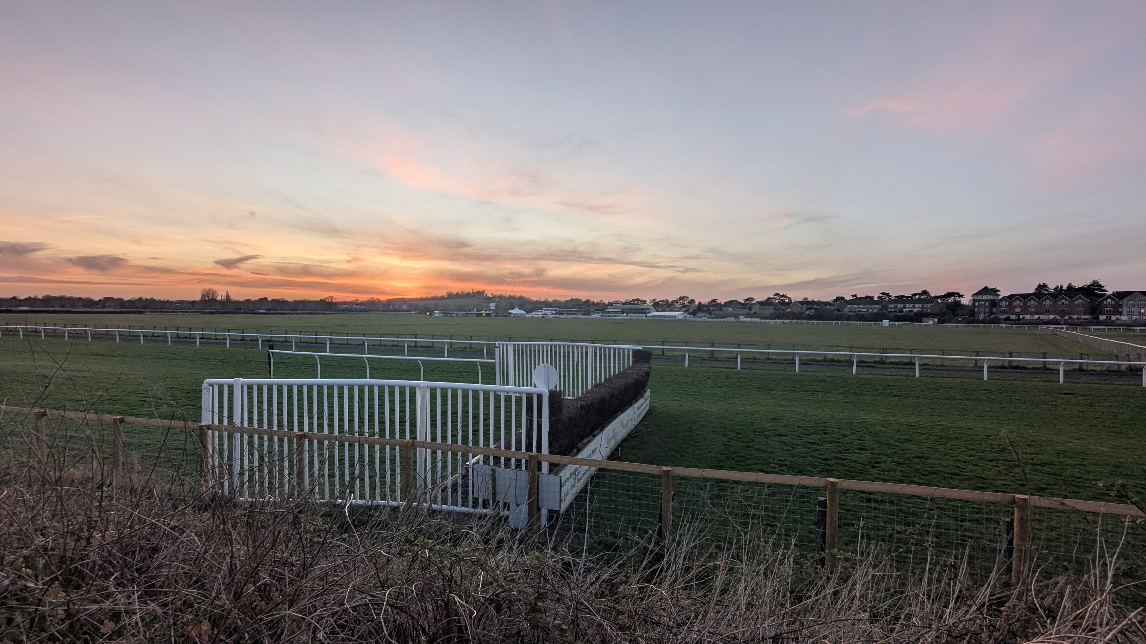 Sunset over Stratford-on-Avon racecourse, an open ditch and its wings standing against the last light.