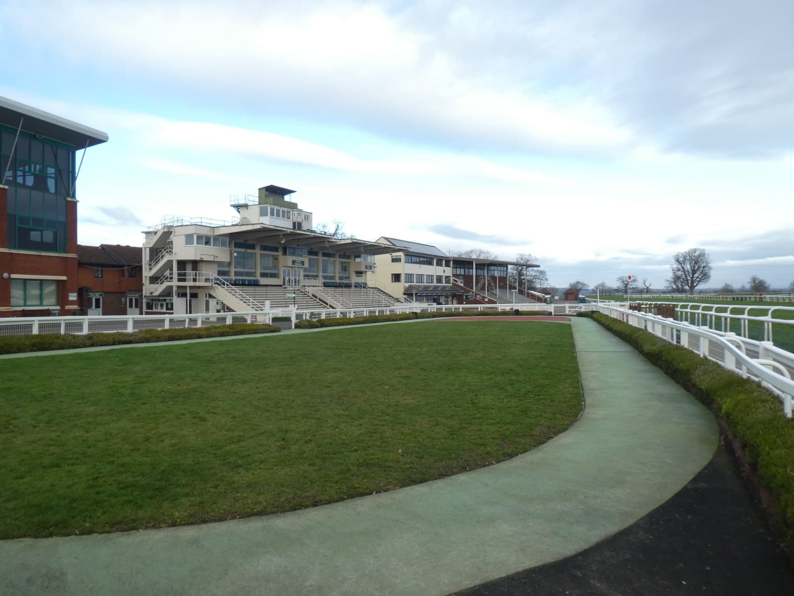 The parade ring and horsewalk at Taunton with the stands rising behind them.