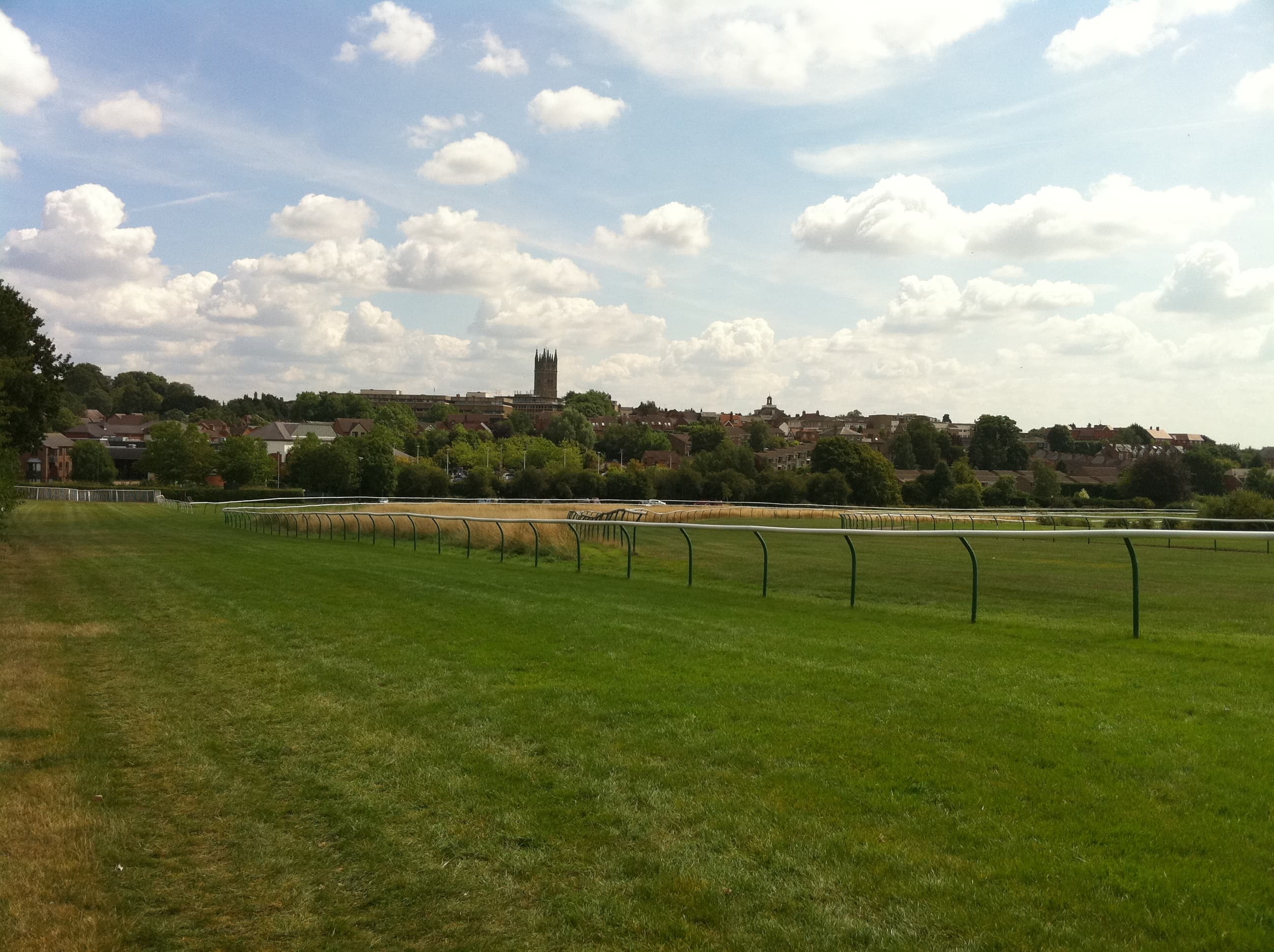 Warwick Racecourse looking across the turf to the town, the tower of St Mary's on the skyline.