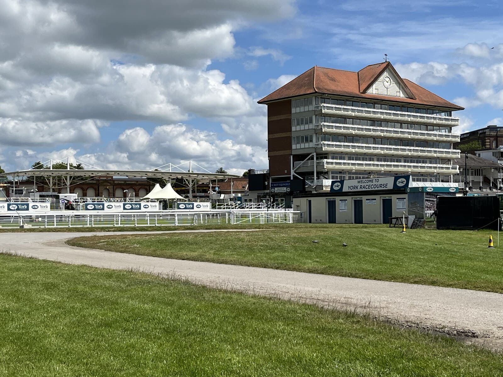 The Ebor stand and the Welcome to York Racecourse board seen from the Knavesmire path.
